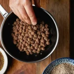 Home 19 스웨덴 미트볼 만들기 - **Prompt 1: The Initial Preparation of Swedish Meatballs**
A close-up, high-angle shot of a home...