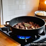 Home 21 프랑스식 고기 스튜 기본 요리법 - A rustic kitchen scene featuring a heavy-duty Dutch oven on a wooden stove with chunks of well-marbl...