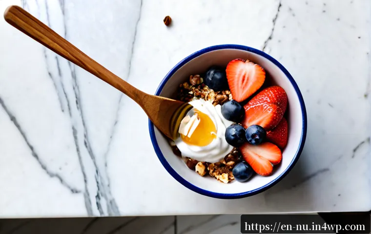 Home 17 그리스식 요거트 활용 요리법 - Photorealistic overhead kitchen scene of a creamy Greek yogurt breakfast bowl topped with fresh blue...